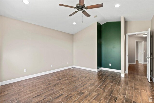 empty room with dark wood finished floors, baseboards, vaulted ceiling, and ceiling fan
