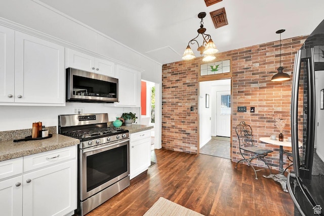 408 E 1700 S, Salt Lake City, UT 84115 - kitchen featuring visible vents, brick wall, appliances with stainless steel finishes, dark wood-style floors, and white cabinetry