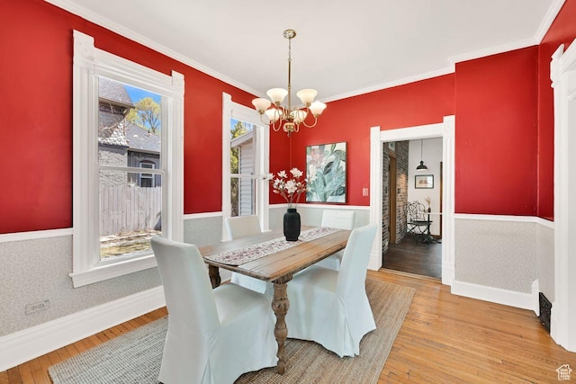 408 E 1700 S, Salt Lake City, UT 84115 - dining room featuring light wood-type flooring, an inviting chandelier, crown molding, and a healthy amount of sunlight