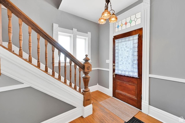408 E 1700 S, Salt Lake City, UT 84115 - entrance foyer with baseboards, light wood finished floors, a chandelier, and stairs