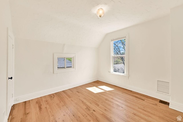 408 E 1700 S, Salt Lake City, UT 84115 - additional living space featuring visible vents, baseboards, light wood-type flooring, and vaulted ceiling