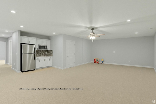 kitchen featuring stainless steel appliances, light carpet, recessed lighting, and ceiling fan