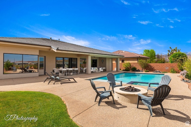 view of pool with a fenced in pool, a patio area, an outdoor fire pit, and fence