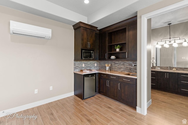 kitchen featuring stainless steel appliances, light countertops, open shelves, an AC wall unit, and baseboards