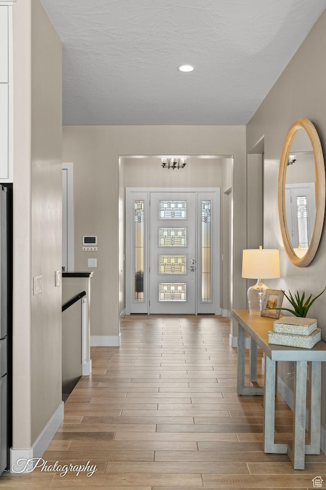 entryway featuring recessed lighting, baseboards, and wood finished floors