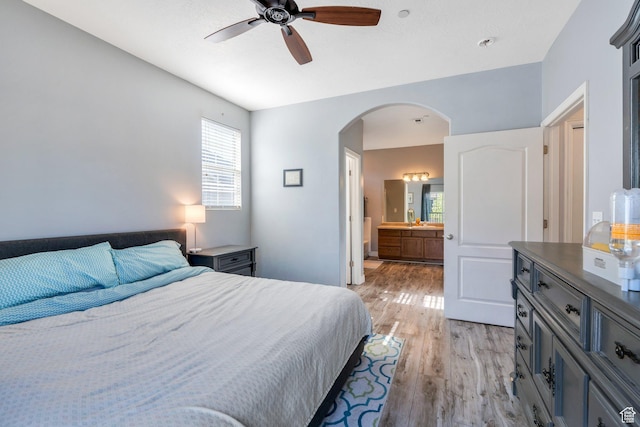 1113 W 160 N, Pleasant Grove, UT 84062 - bedroom featuring light wood-style flooring, arched walkways, ensuite bath, and a ceiling fan