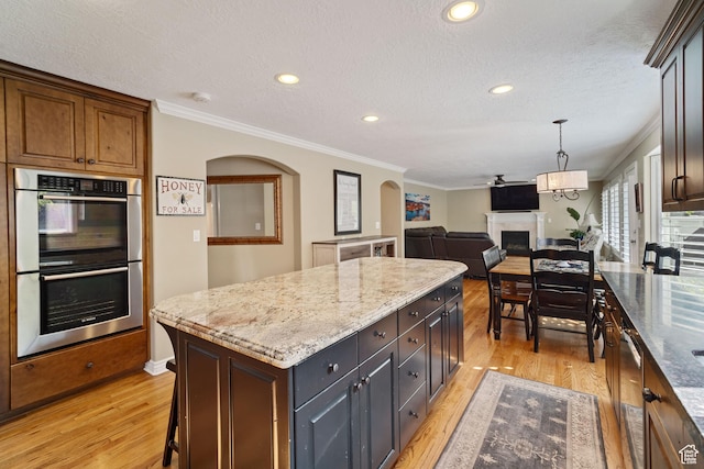1778 E Indian Wells Ln, Draper, UT 84020 - kitchen featuring a center island, ornamental molding, light wood-type flooring, a fireplace, and double oven
