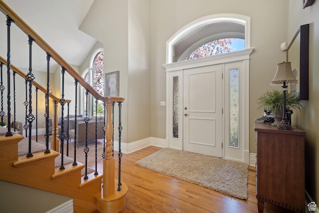 1778 E Indian Wells Ln, Draper, UT 84020 - foyer entrance with high vaulted ceiling, stairs, baseboards, and wood finished floors