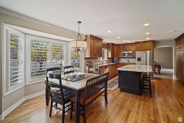 1778 E Indian Wells Ln, Draper, UT 84020 - dining area with baseboards, recessed lighting, a textured ceiling, arched walkways, and light wood finished floors