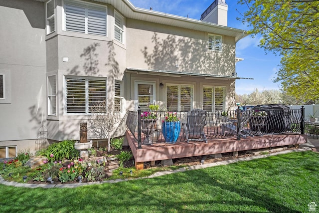 1778 E Indian Wells Ln, Draper, UT 84020 - back of property with a wooden deck, stucco siding, a lawn, fence, and a chimney