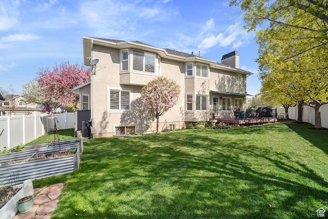 1778 E Indian Wells Ln, Draper, UT 84020 - back of property featuring a garden, a chimney, a fenced backyard, and a lawn