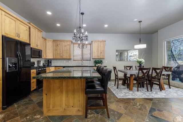 kitchen featuring black appliances, recessed lighting, a breakfast bar, a center island, and stone tile flooring