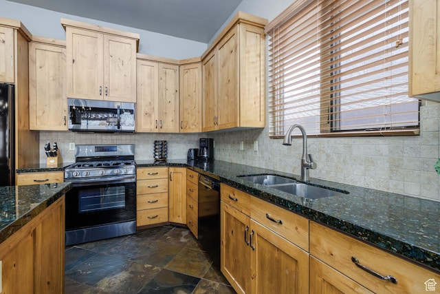 kitchen with a sink, black appliances, and light brown cabinetry