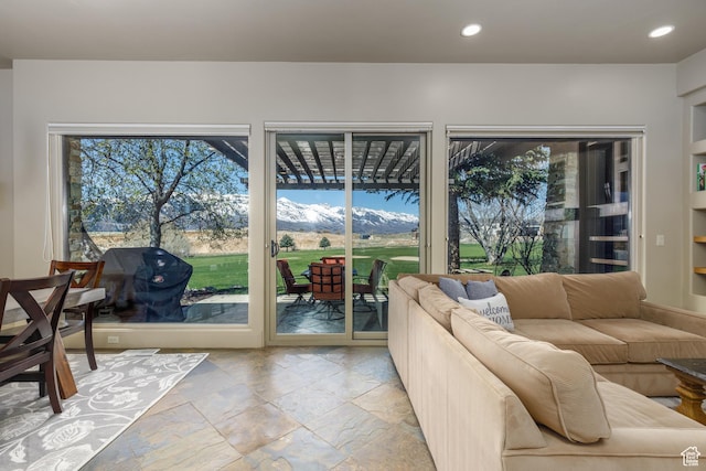 living room featuring stone tile floors and recessed lighting