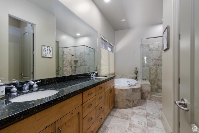 full bathroom with a shower stall, a bath, double vanity, and a sink