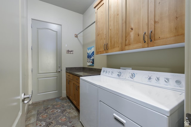 washroom featuring cabinet space and separate washer and dryer