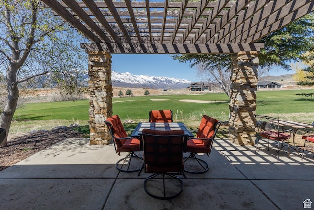 view of patio with a mountain view, a pergola, and outdoor dining area