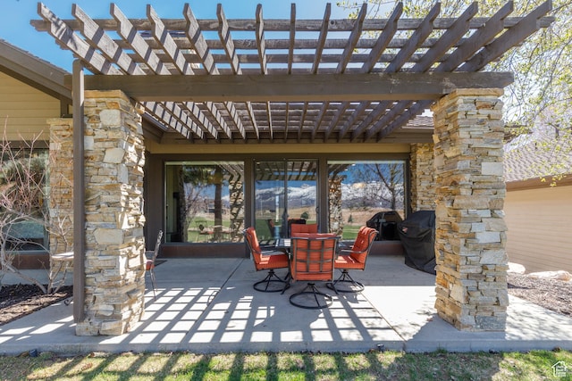 view of patio featuring a pergola, grilling area, and outdoor dining space