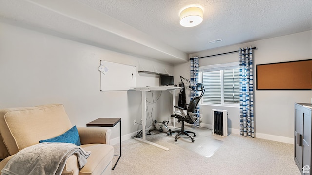 carpeted home office featuring visible vents, a textured ceiling, and baseboards