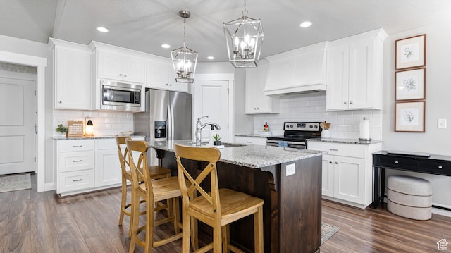 kitchen with custom exhaust hood, an inviting chandelier, dark wood-style flooring, appliances with stainless steel finishes, and decorative backsplash