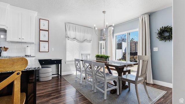 dining area with a notable chandelier, dark wood-style floors, baseboards, and a textured ceiling