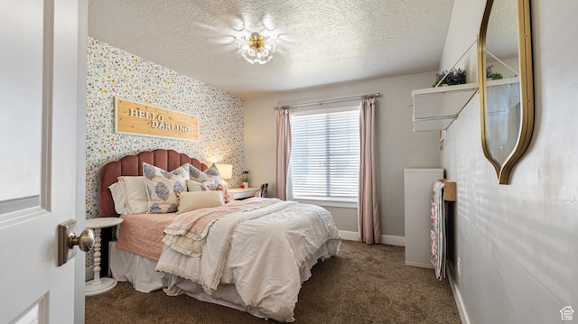 carpeted bedroom with baseboards, a textured ceiling, and wallpapered walls