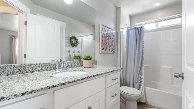full bathroom with vanity, tile patterned floors, a textured ceiling, toilet, and shower / bath combo with shower curtain