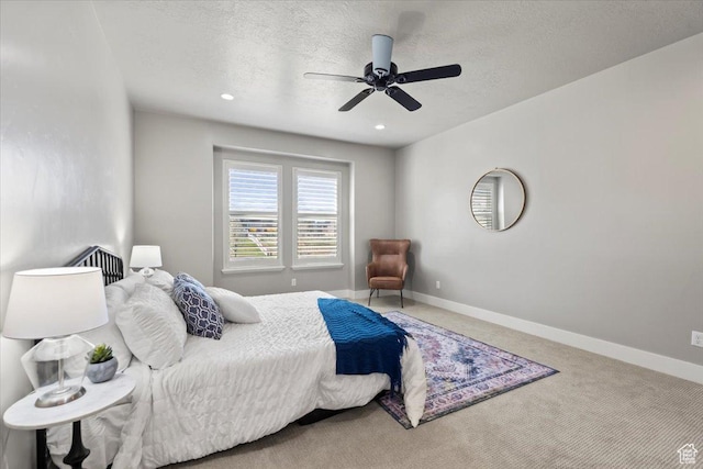 bedroom featuring baseboards, carpet flooring, ceiling fan, and a textured ceiling