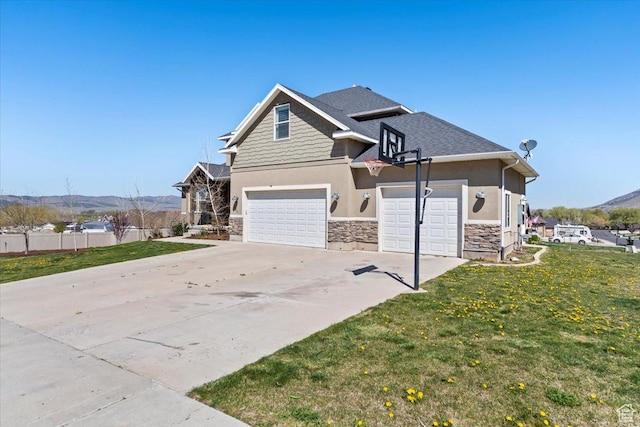 craftsman inspired home with an attached garage, stone siding, concrete driveway, stucco siding, and a front lawn