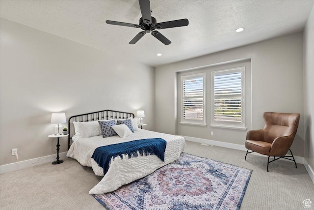 carpeted bedroom featuring recessed lighting, baseboards, a textured ceiling, and ceiling fan