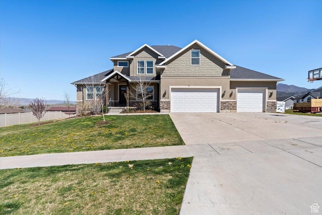 craftsman-style house featuring stone siding, fence, a front lawn, an attached garage, and concrete driveway