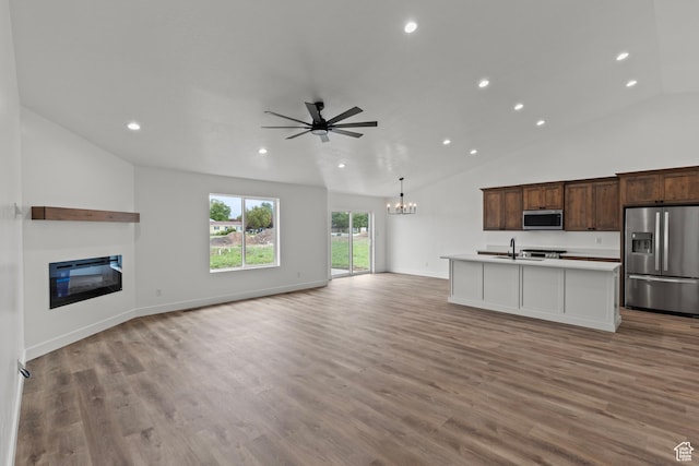 232 N 300 W, Preston, ID 83263 - kitchen with appliances with stainless steel finishes, open floor plan, a chandelier, vaulted ceiling, and recessed lighting