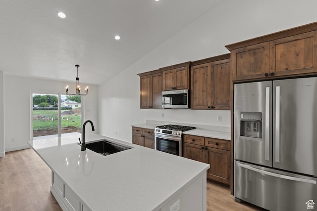 232 N 300 W, Preston, ID 83263 - kitchen with appliances with stainless steel finishes, a sink, vaulted ceiling, a chandelier, and light wood-style floors