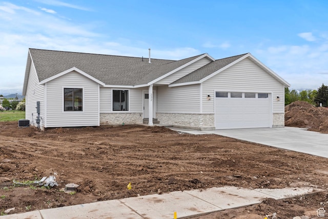 232 N 300 W, Preston, ID 83263 - ranch-style house featuring stone siding, a garage, roof with shingles, driveway, and central air condition unit
