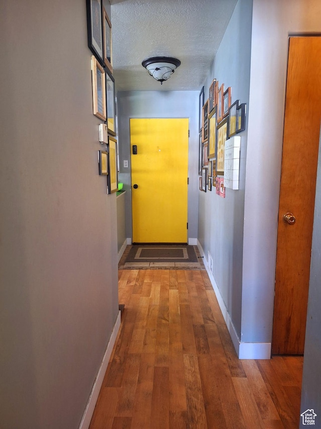 3150 N Iowa Ave W, Ogden, UT 84403 - corridor with wood-type flooring, baseboards, and a textured ceiling
