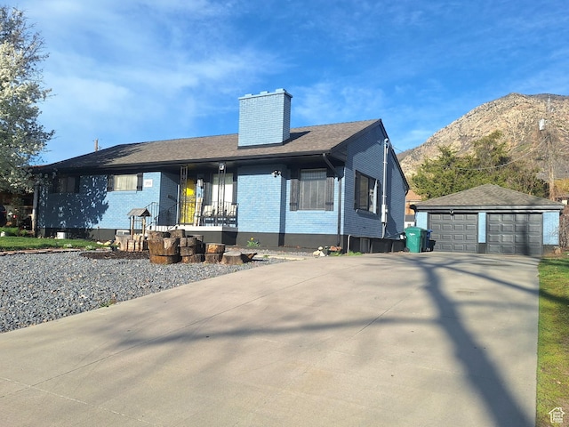 3150 N Iowa Ave W, Ogden, UT 84403 - ranch-style house featuring a chimney, a mountain view, a detached garage, brick siding, and an outbuilding