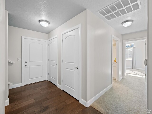 1262 S 50 E Unit 3, Lehi, UT 84043 - hallway with dark wood-type flooring, visible vents, baseboards, and a textured ceiling