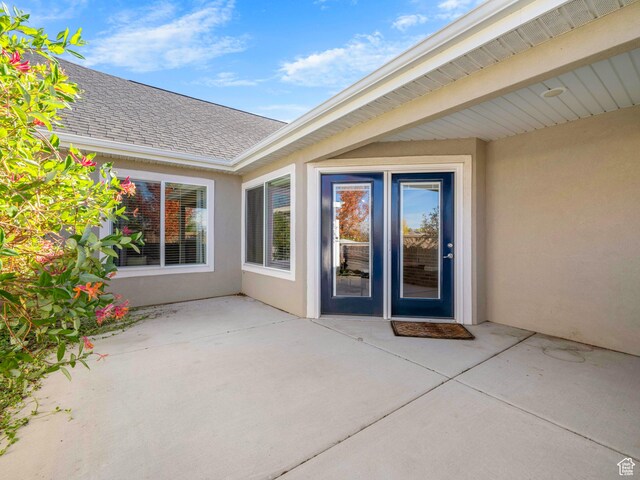 1262 S 50 E Unit 3, Lehi, UT 84043 - view of exterior entry featuring roof with shingles, a patio, and stucco siding