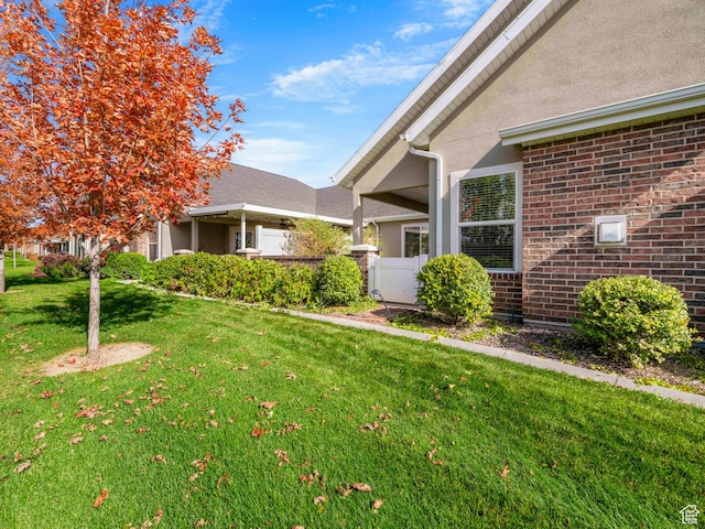 1262 S 50 E Unit 3, Lehi, UT 84043 - view of property exterior with a yard, fence, and stucco siding