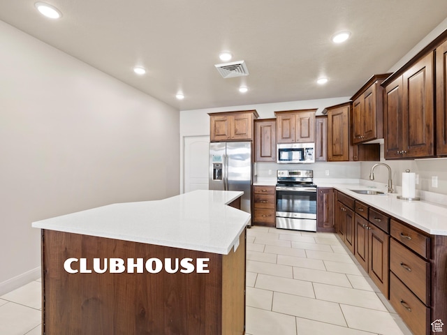 1262 S 50 E Unit 3, Lehi, UT 84043 - kitchen with visible vents, a center island, light tile patterned floors, a sink, and appliances with stainless steel finishes