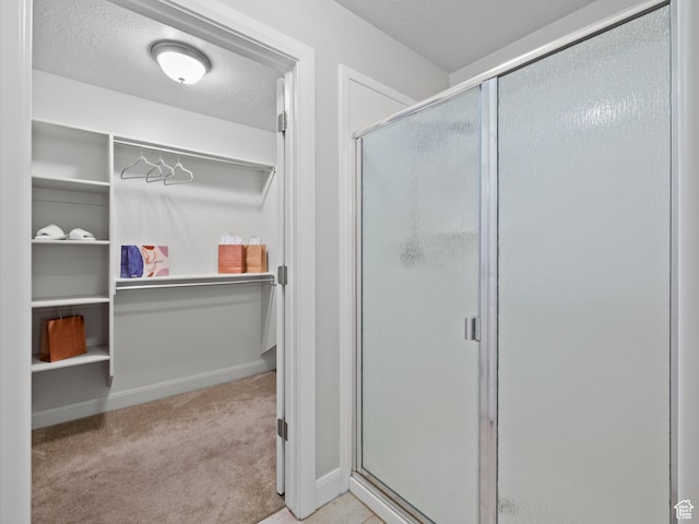 1262 S 50 E Unit 3, Lehi, UT 84043 - full bathroom featuring a shower stall, a textured ceiling, and a spacious closet