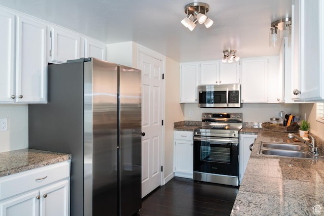 kitchen with tile counters, white cabinetry, dark wood-type flooring, appliances with stainless steel finishes, and a sink