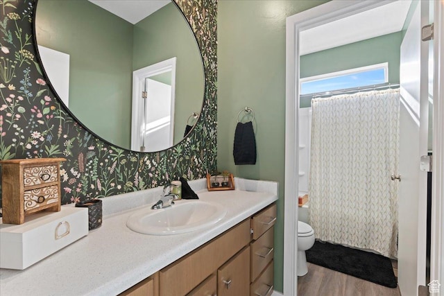 bathroom featuring a shower with shower curtain, vanity, toilet, and wood finished floors