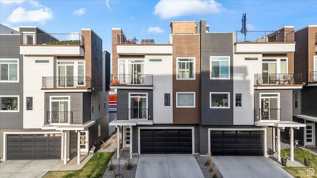 townhome / multi-family property with an attached garage and concrete driveway