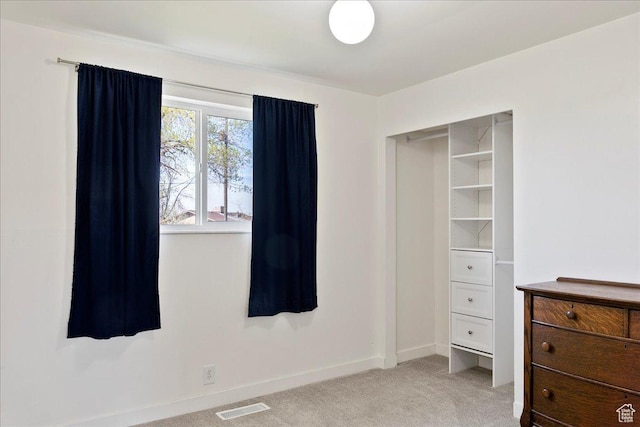 bedroom featuring light colored carpet, baseboards, and visible vents