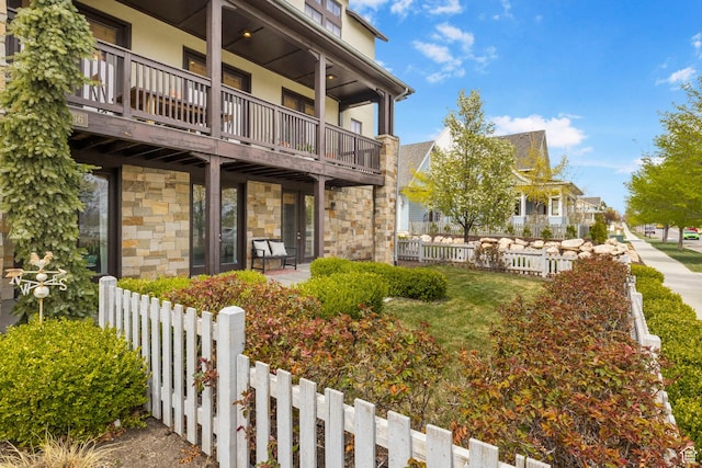 exterior space featuring fence and a balcony