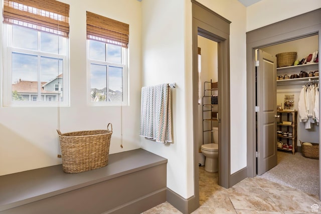 bathroom with baseboards and toilet
