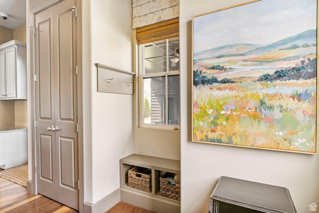 mudroom with wood finished floors and baseboards