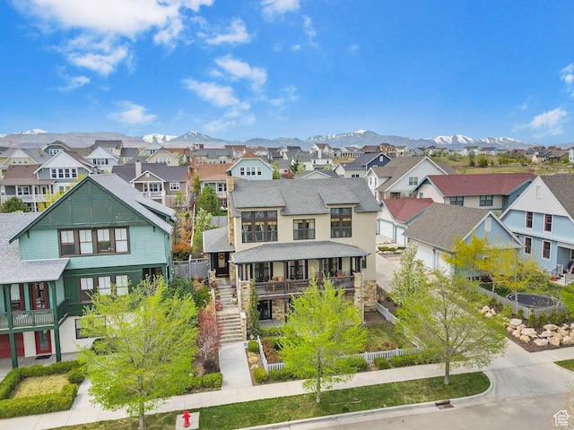 exterior space with a residential view, fence private yard, driveway, stairs, and a shingled roof