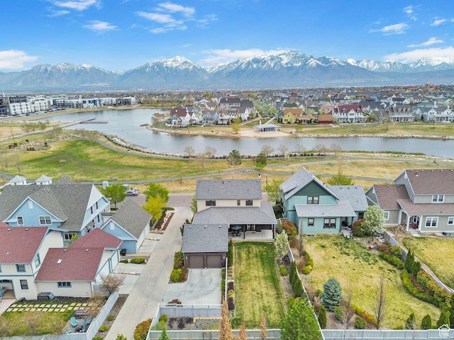 drone / aerial view with a water and mountain view and a residential view
